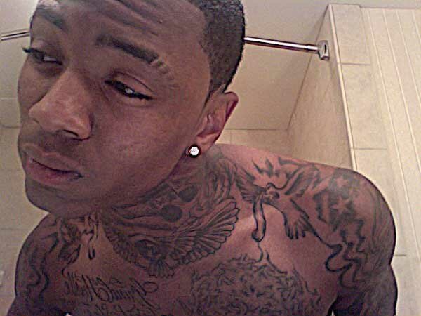 Picture of Soulja Boy neck and shoulder tattoos in mirror