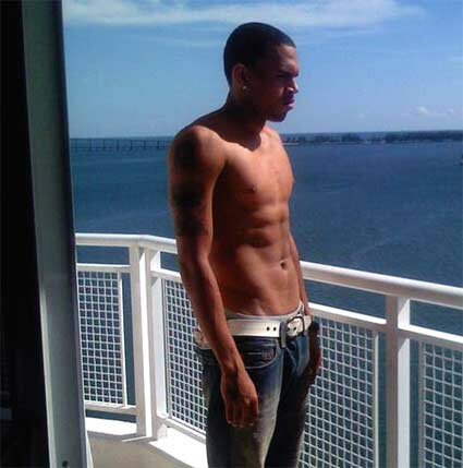 Photo of shirtless Chris Brown on the balcony