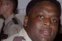 Photo Close-Up of Rick Ross in Correctional Officer Uniform