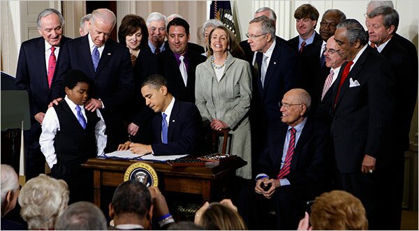 Photo of President Barack Obama Signing Health Care Reform Bill Into Law
