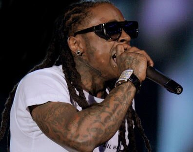 Picture of rap artist Lil Wayne performing on stage holding a microphone