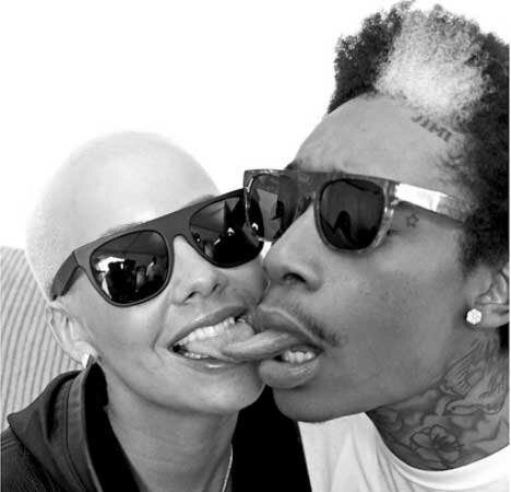 Photo of Amber Rose and Wiz Khalifa kissing with tongue